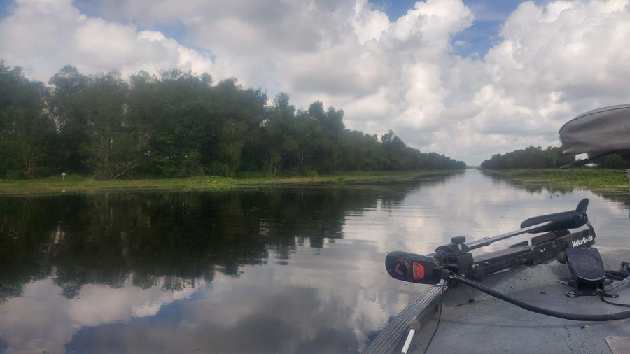 Boat deck beside calm Louisiana canal water