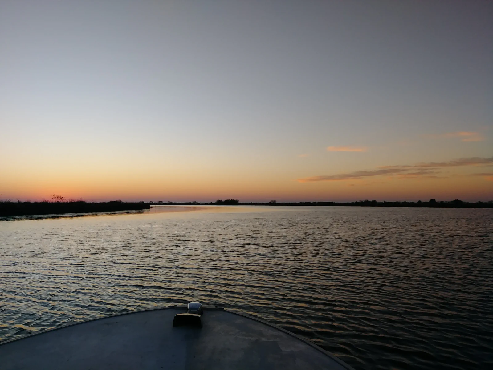 Sunset over moving marsh water in Southeast Louisiana